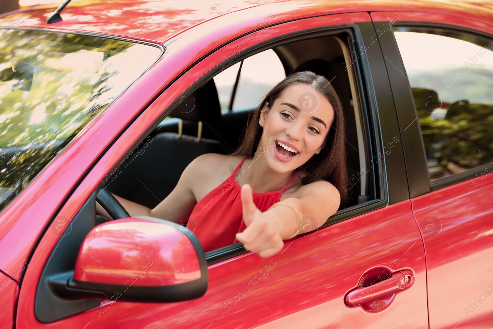 Photo of Happy young beautiful woman driving modern car