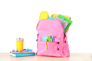 Photo of Color backpack with stationery on white background. Ready for school