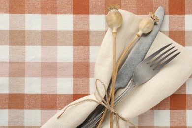 Photo of Stylish setting with cutlery and napkin on table, top view. Space for text