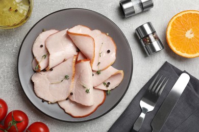 Photo of Delicious cut ham with thyme and peppercorns served on light grey table, flat lay