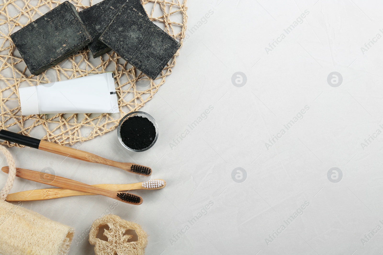 Photo of Flat lay composition with bamboo toothbrushes on light table. Space for text