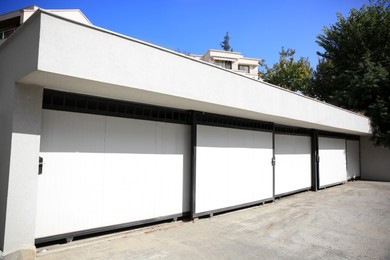 Building with white automatic garage doors in city