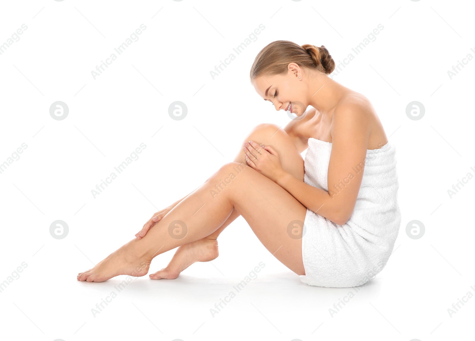 Photo of Portrait of young pretty woman with towel sitting on white background