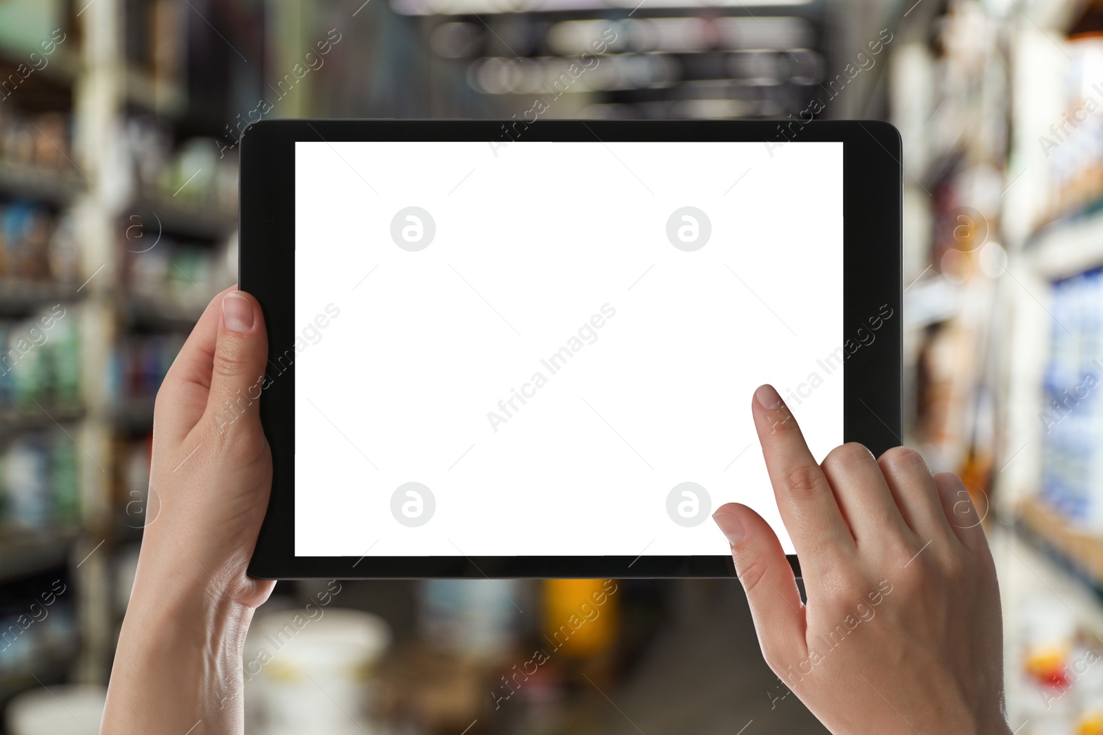 Image of Wholesale trading. Woman using WMS app on tablet at warehouse, closeup 