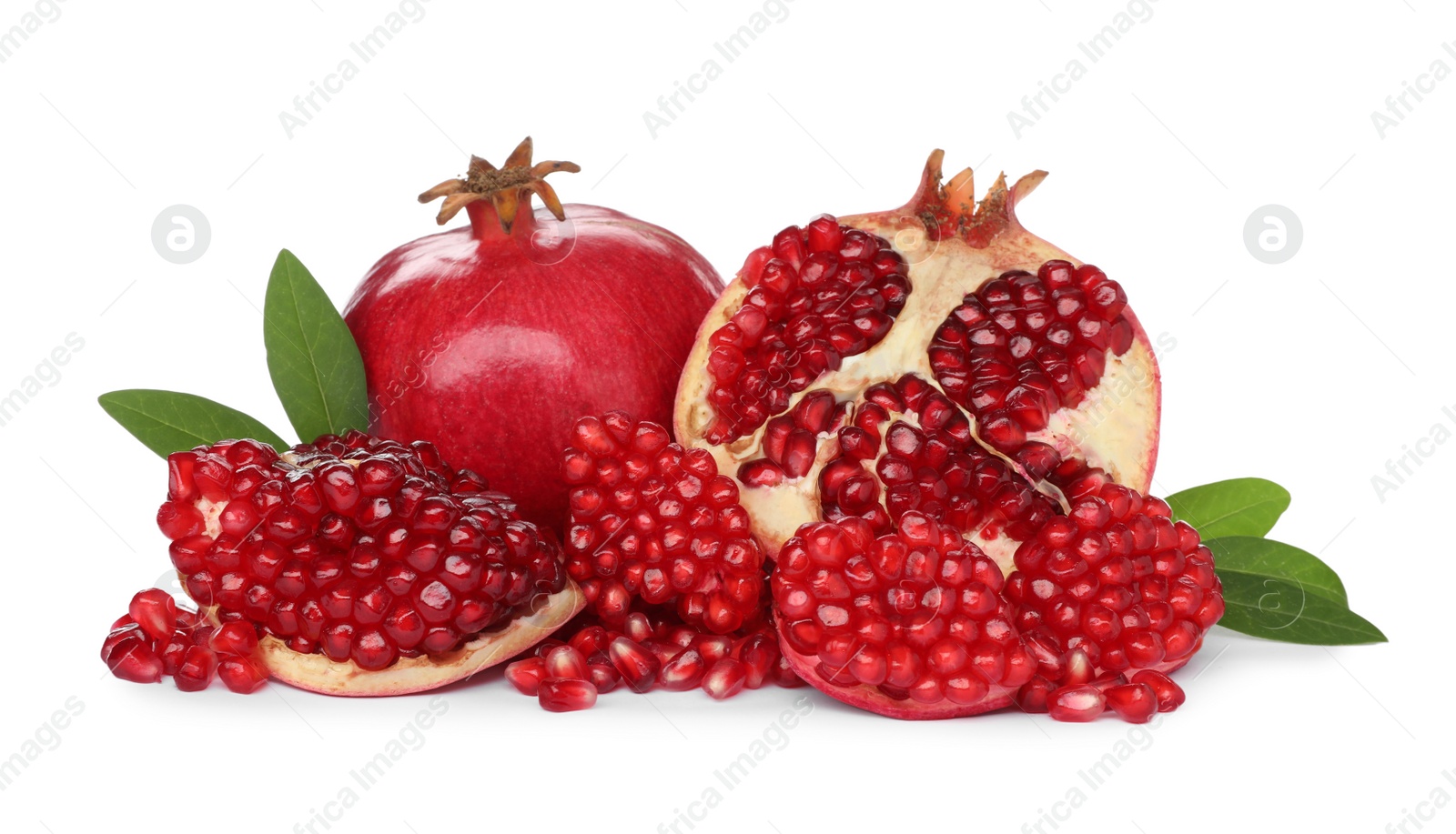 Photo of Tasty ripe pomegranates and leaves on white background