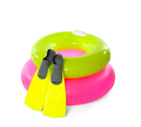 Inflatable rings and flippers on white background. Summer holidays