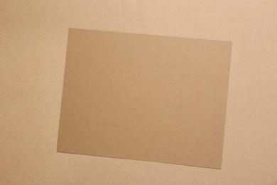 Photo of Piece of cardboard on color background, top view