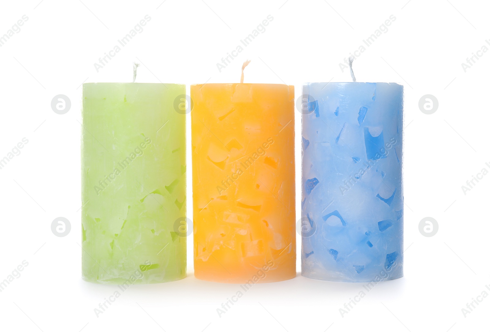 Photo of Three color wax candles on white background