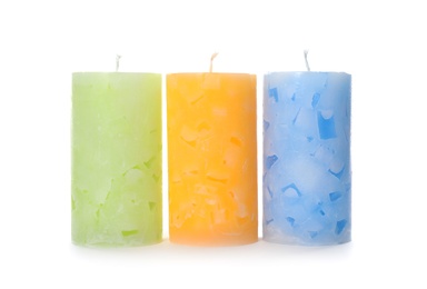 Three color wax candles on white background