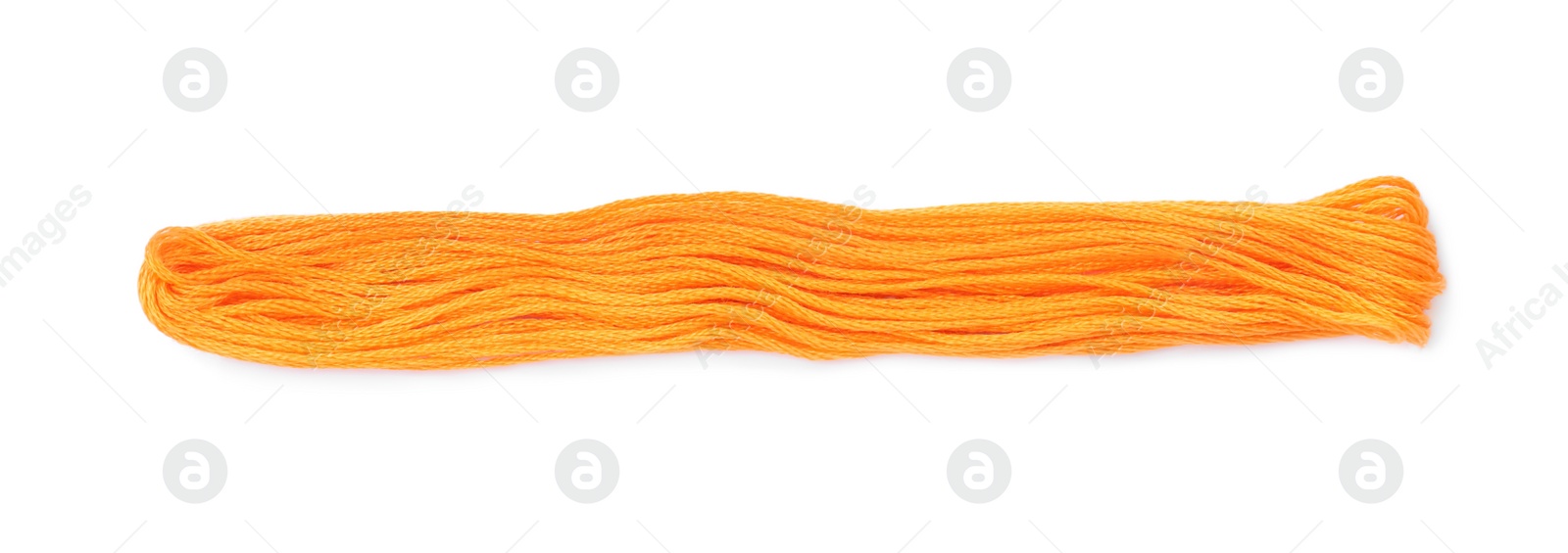 Photo of Bright orange embroidery thread on white background