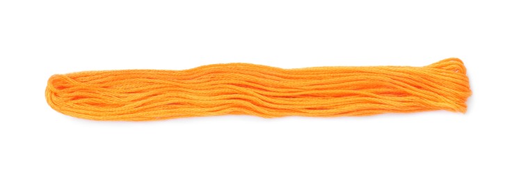 Bright orange embroidery thread on white background
