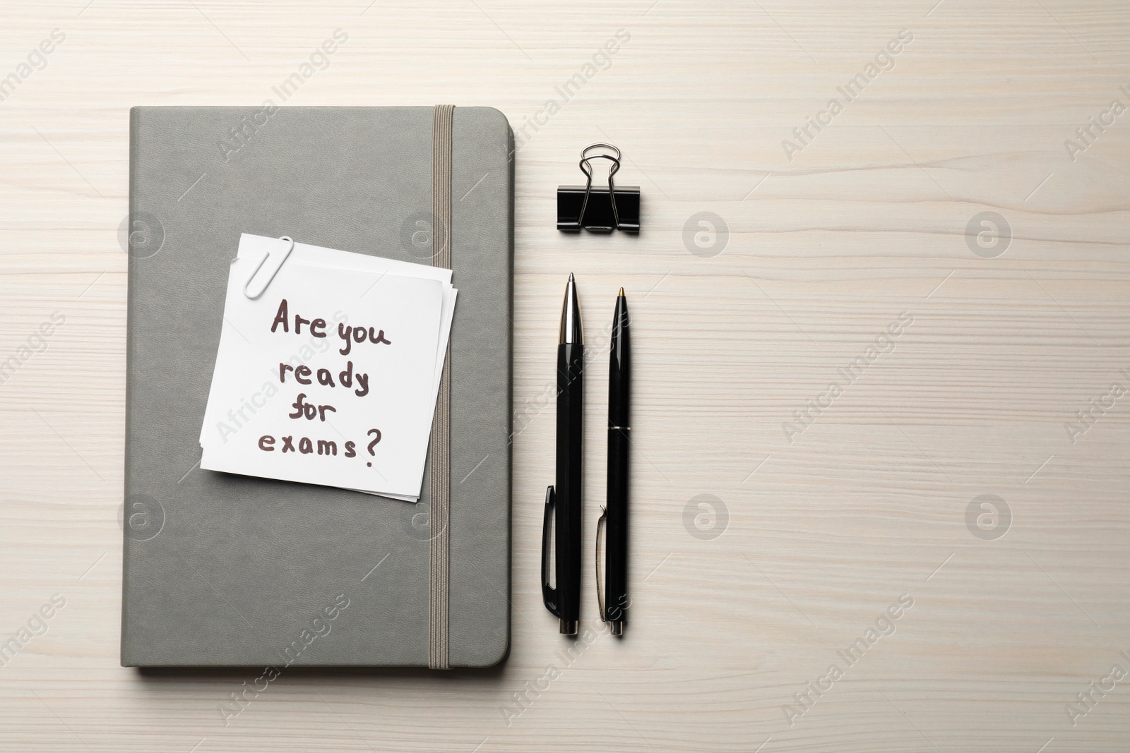 Photo of Note with question Are You Ready For Exams? on white wooden table, flat lay. Space for text