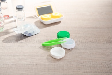 Photo of Contact lens accessories on wooden table