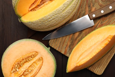 Tasty fresh melons on wooden table, flat lay