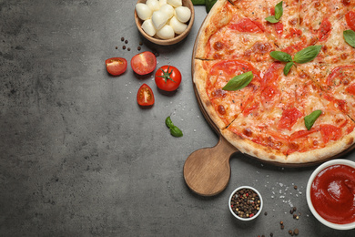 Photo of Delicious pizza Margherita and ingredients on grey table, flat lay. Space for text