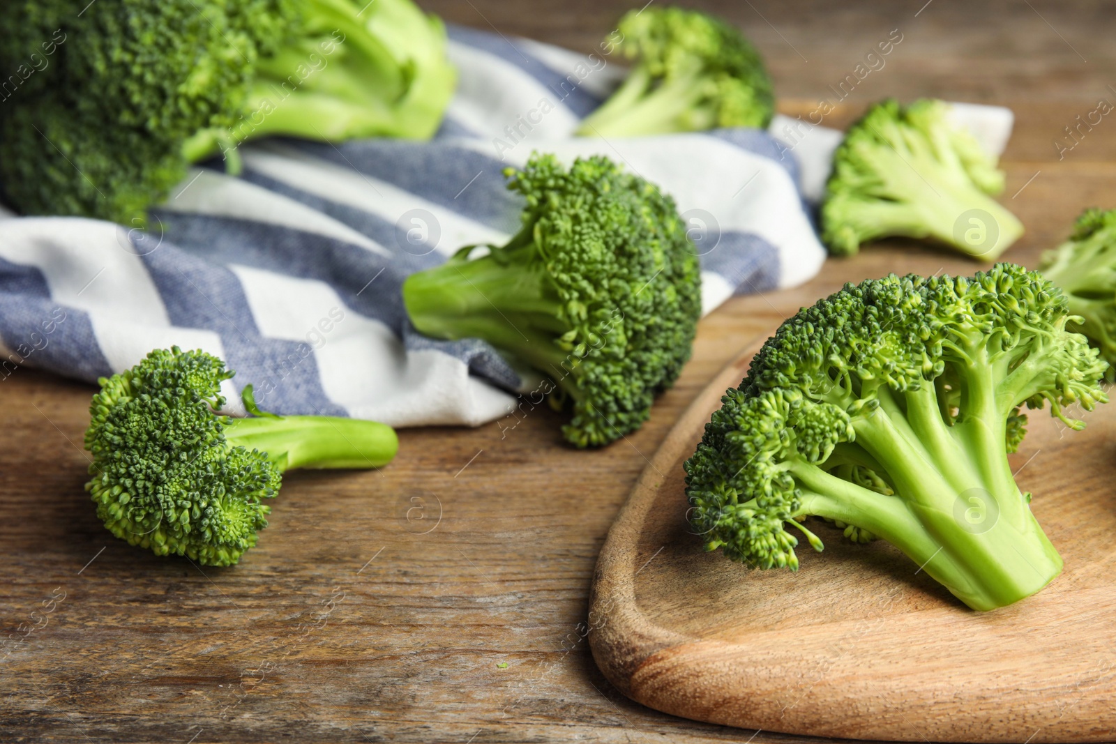 Photo of Fresh green broccoli on wooden table. Organic food