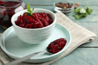 Photo of Bowl with delicious pickled beets on blue wooden table