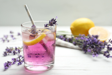 Photo of Fresh delicious lemonade with lavender on white wooden table. Space for text
