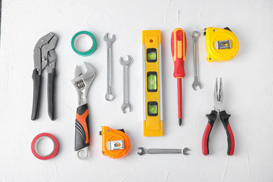 Photo of Flat lay composition with construction tools on white background