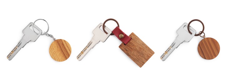 Image of Set of keys with wooden key chains isolated on white