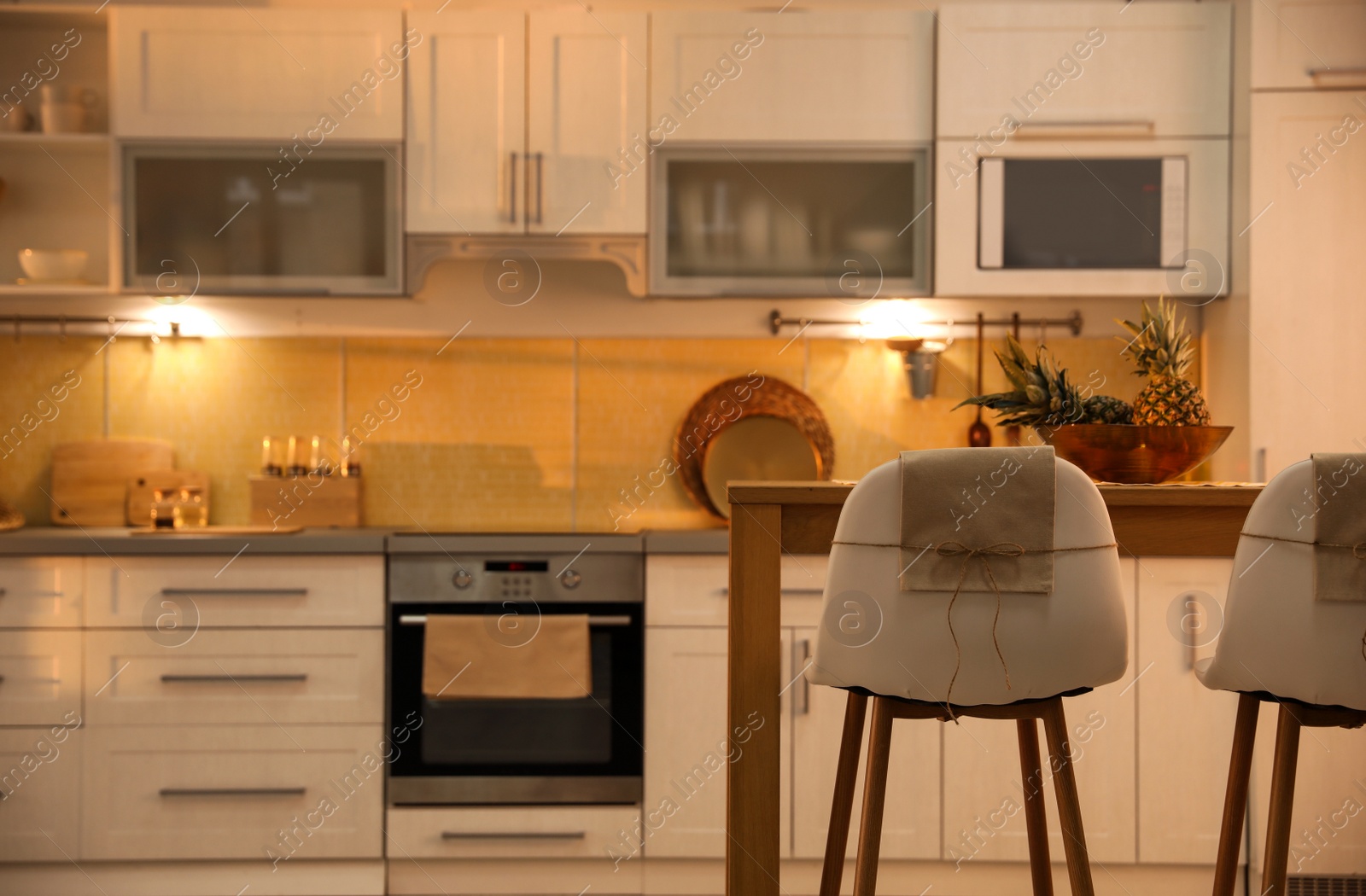 Photo of Modern kitchen interior with stylish wooden table. Space for text