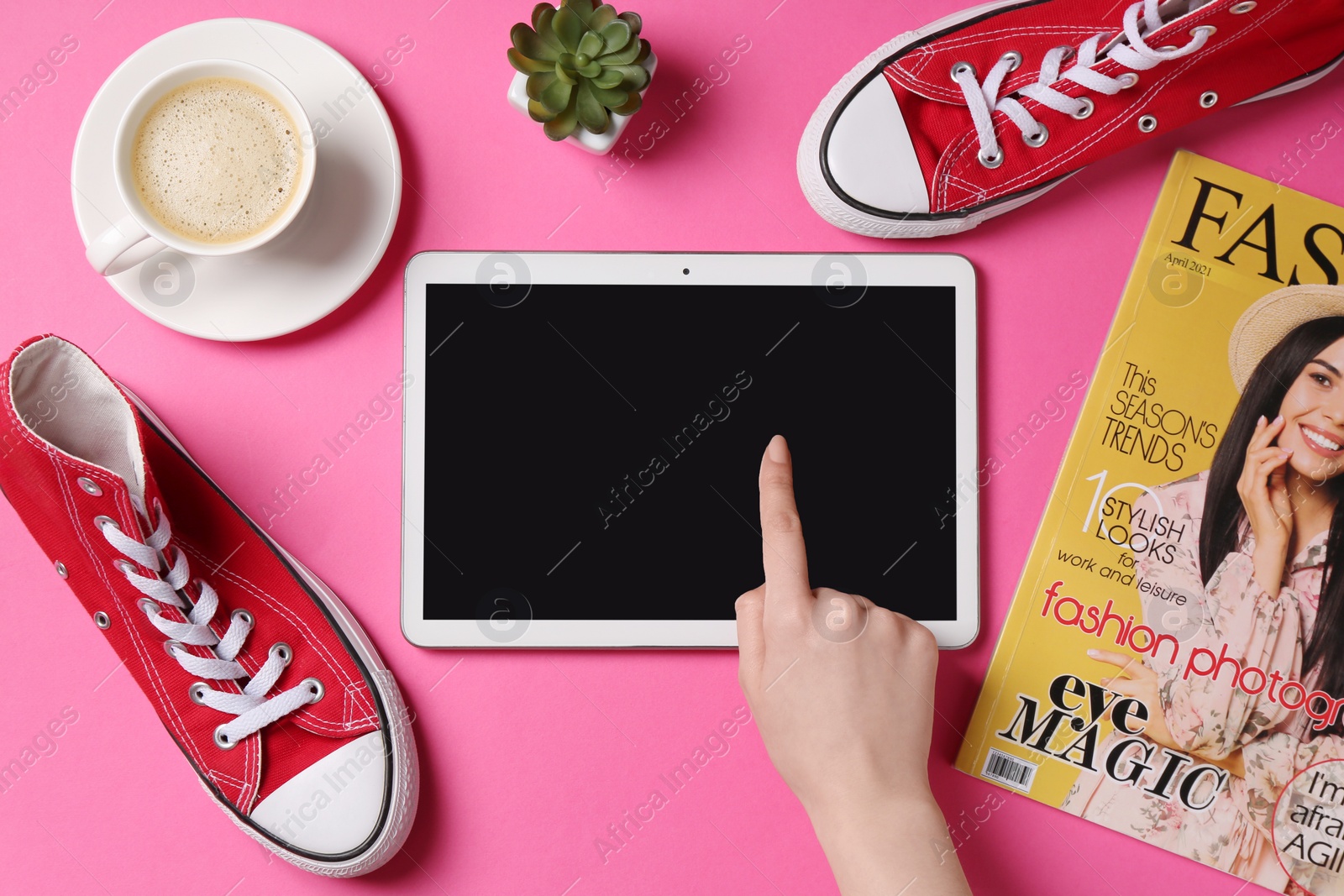 Photo of Online store. Woman using tablet on pink background, top view