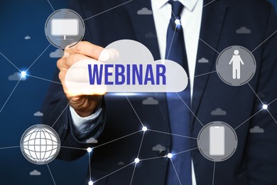 Webinar concept. Closeup view of man near virtual screen with different icons on blue background