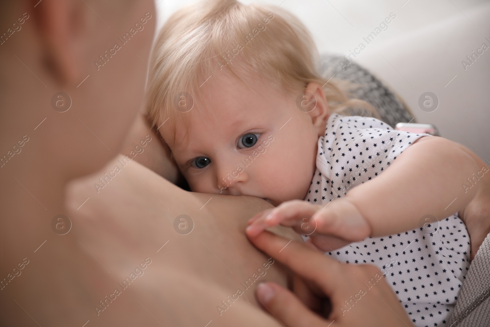 Photo of Mother breastfeeding her cute little baby, closeup