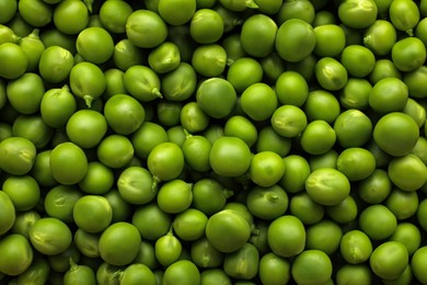 Photo of Fresh raw green peas as background, top view