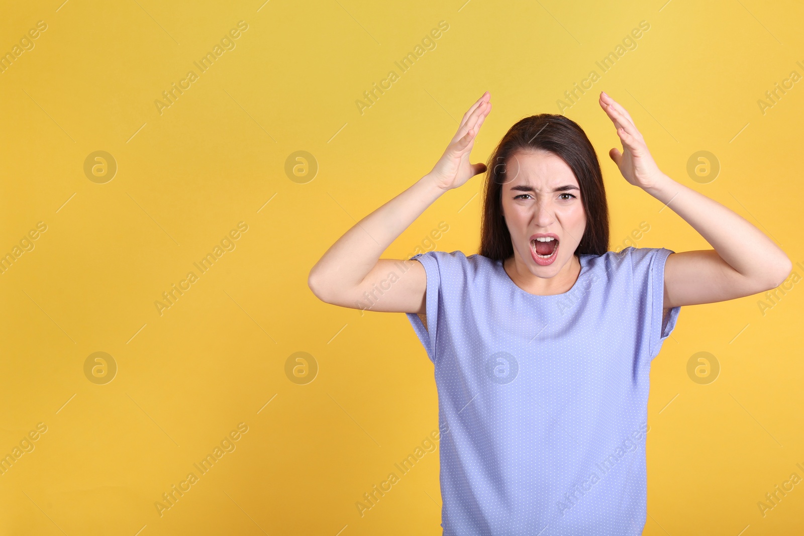 Photo of Portrait of stressed young woman on yellow background. Space for text