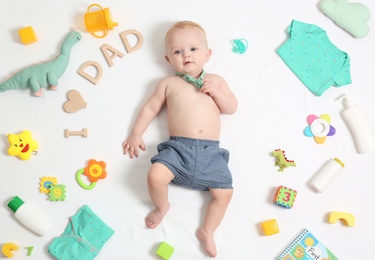 Cute little baby with clothing and accessories on white background, top view