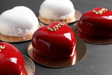 St. Valentine's Day. Delicious heart shaped cakes on black table, closeup