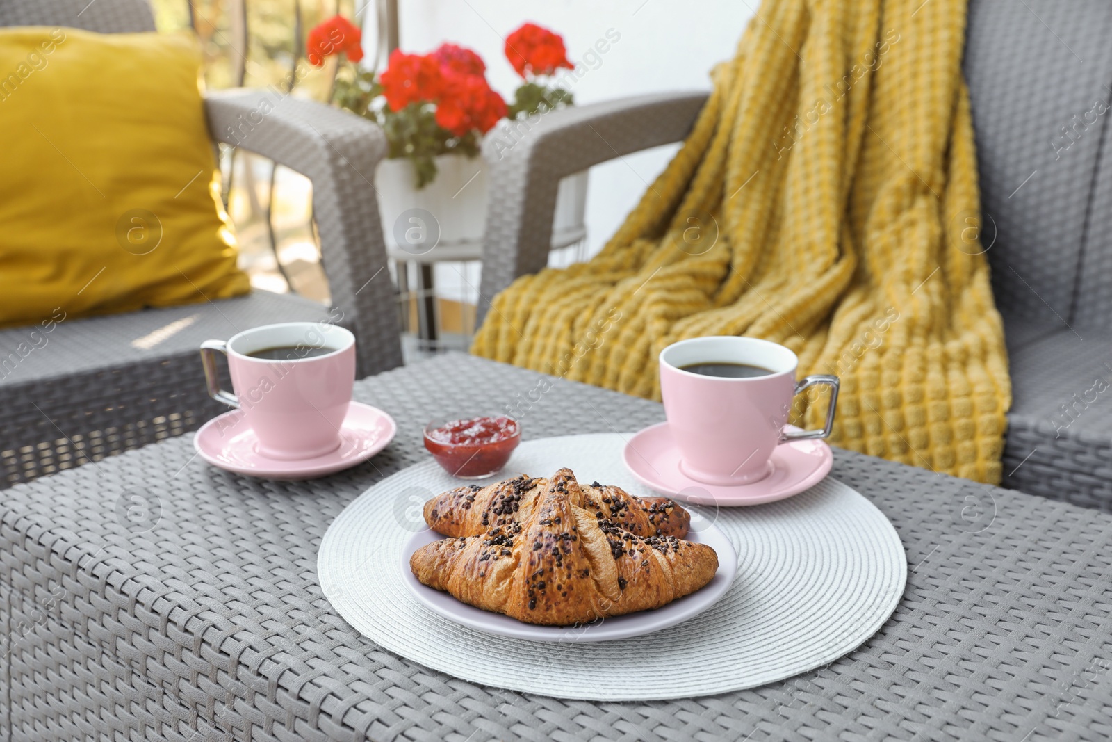 Outdoor breakfast with tea and croissants on white table on terrace Photo of Outdoor breakfast with tea and croissants on white table on terrace