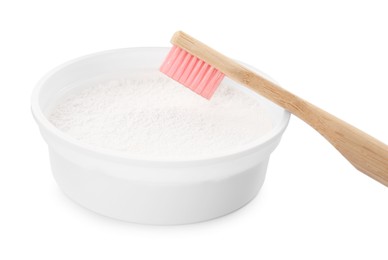 Photo of Bowl of tooth powder and brush on white background