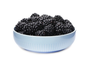 Ceramic bowl of tasty ripe blackberries on white background