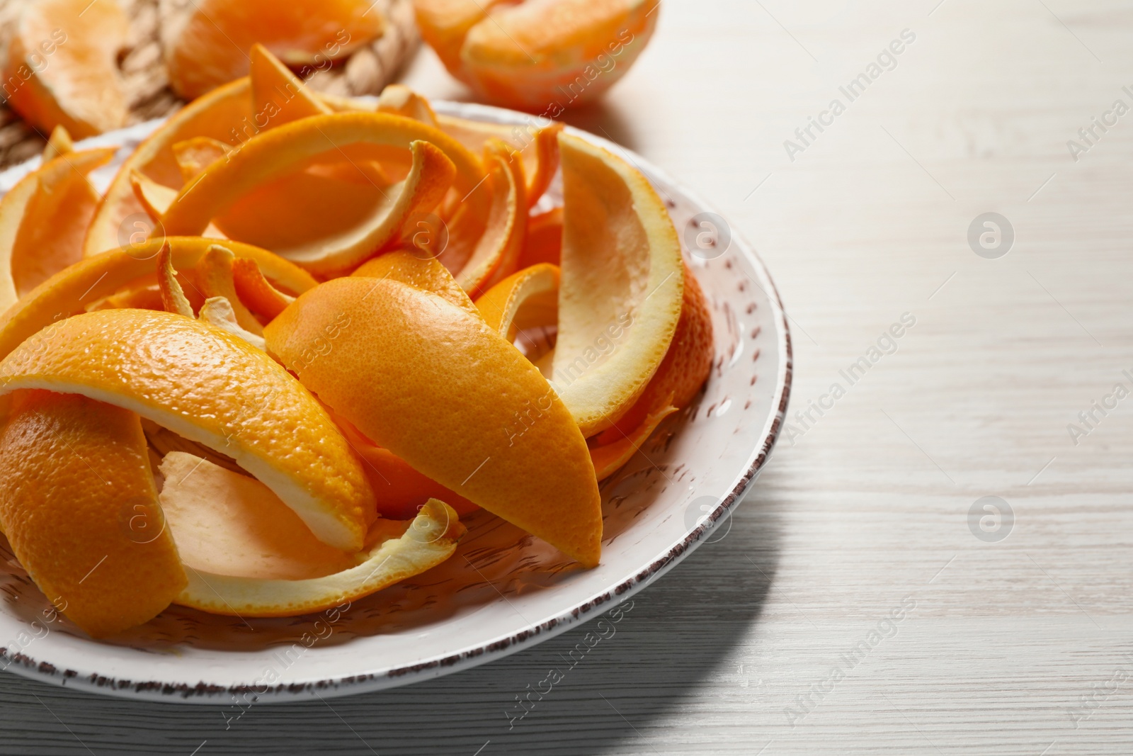 Photo of Orange peels preparing for drying on white wooden table, closeup