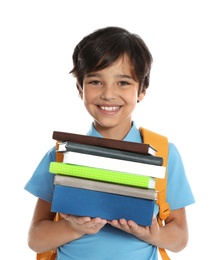 Happy boy in school uniform with stack of books on white background