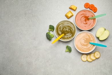 Photo of Healthy baby food and ingredients on grey table, flat lay. Space for text