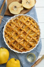 Photo of Tasty homemade quince pie on white wooden table, flat lay