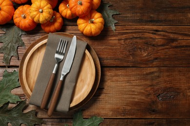 Photo of Happy Thanksgiving day. Autumn table setting, pumpkins and dry leaves on wooden background, flat lay with space for text