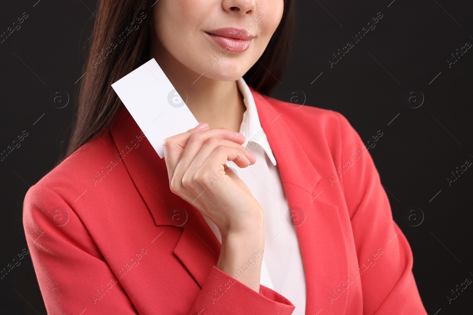 Photo of Woman holding blank business card on black background, closeup. Space for text