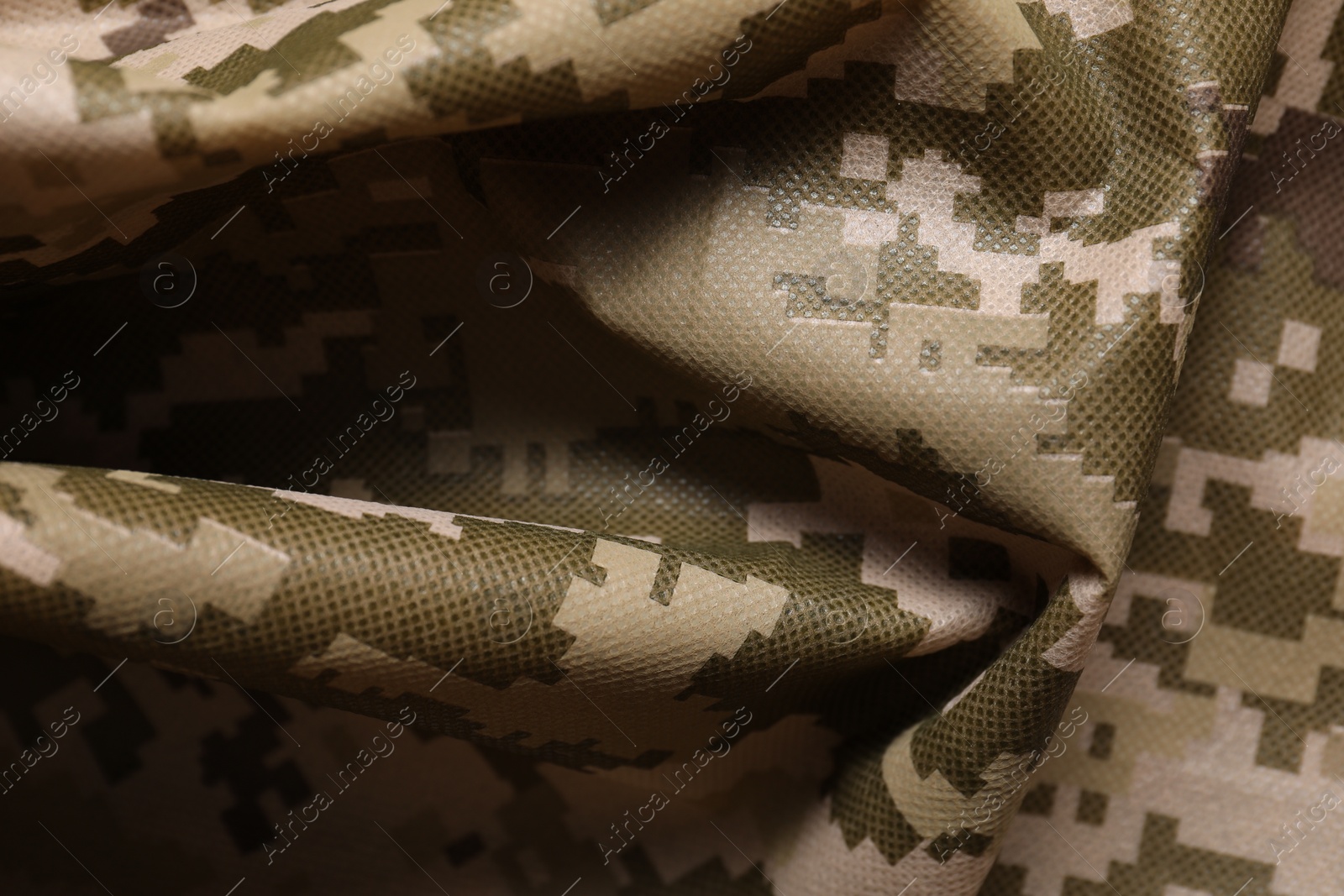 Photo of Texture of crumpled camouflage fabric as background, closeup