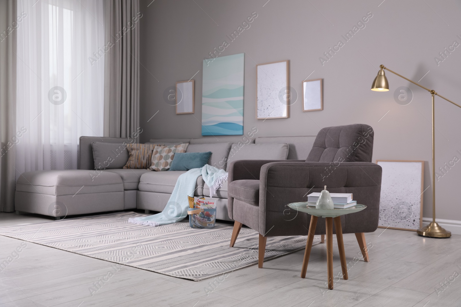 Photo of Stylish living room interior with comfortable armchair and sofa