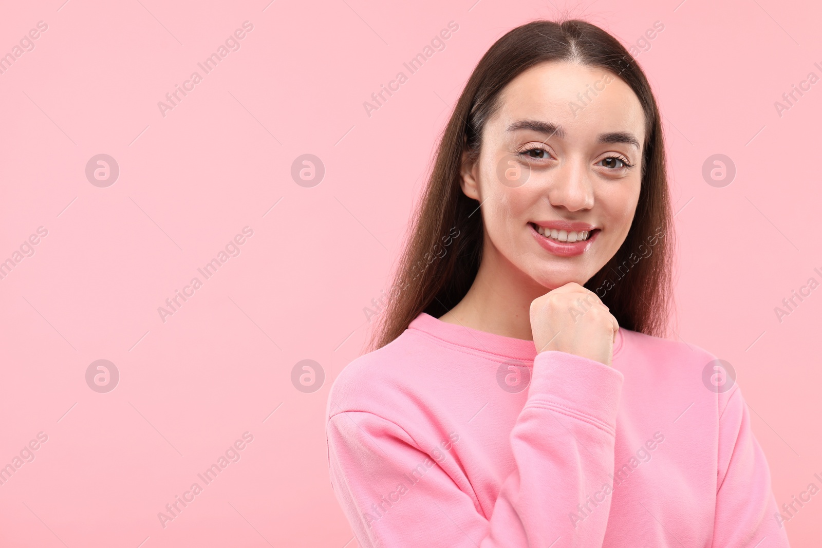 Photo of Beautiful woman with clean teeth smiling on pink background, space for text