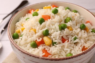Photo of Delicious rice with vegetables in bowl, closeup