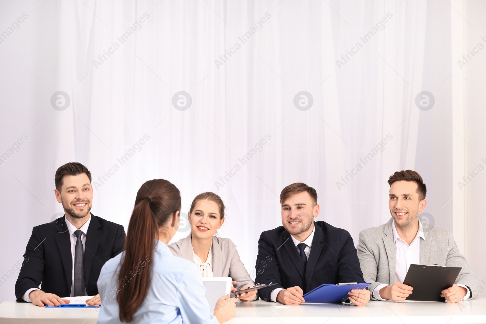 Photo of Human resources commission conducting job interview with applicant, indoors