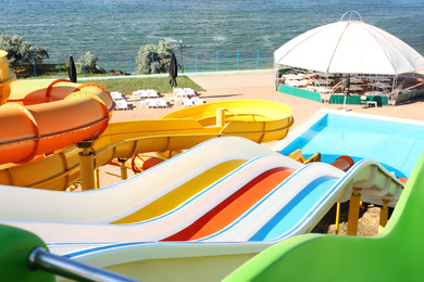 Photo of Different colorful slides in water park on sunny day