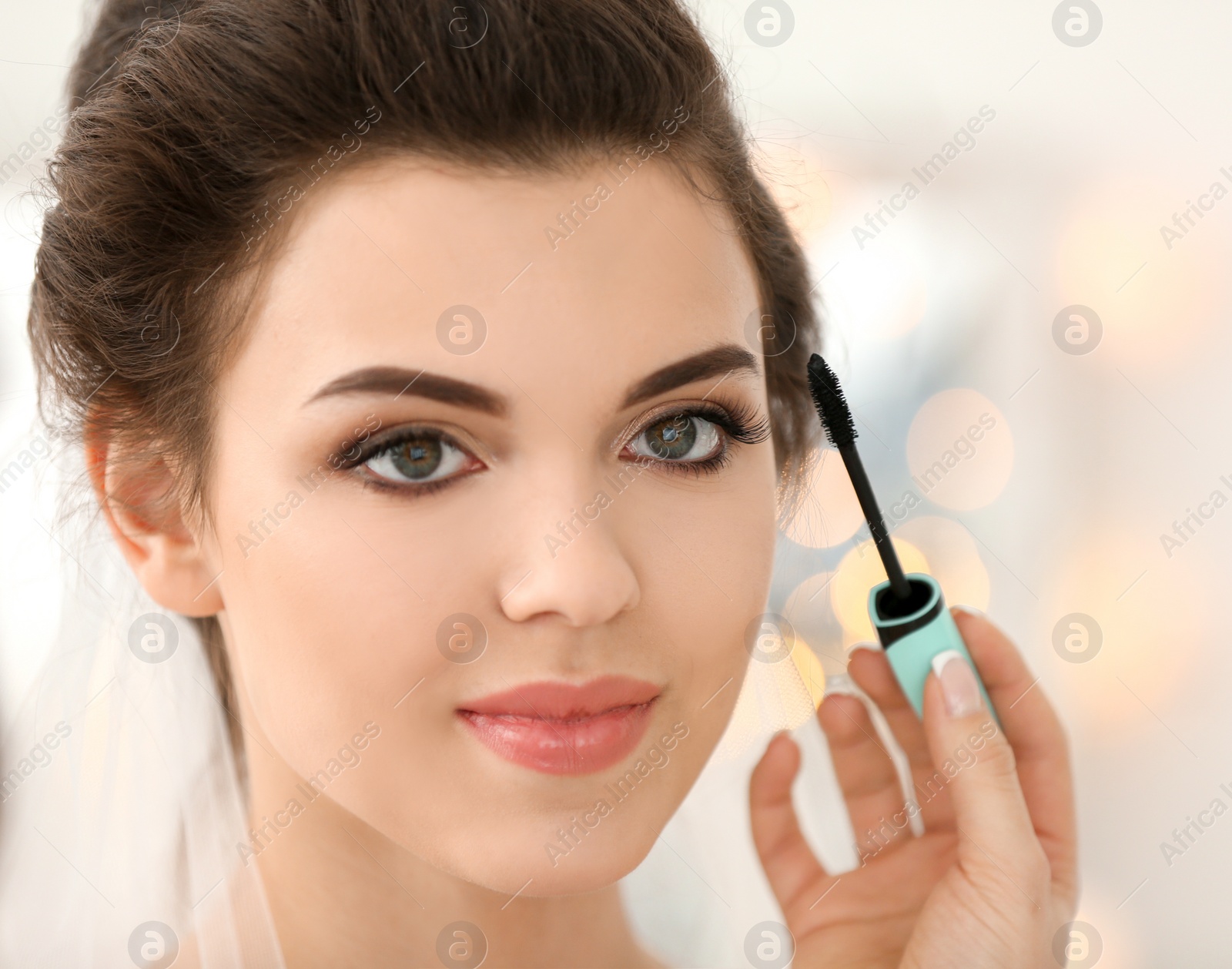 Photo of Makeup artist preparing bride before her wedding