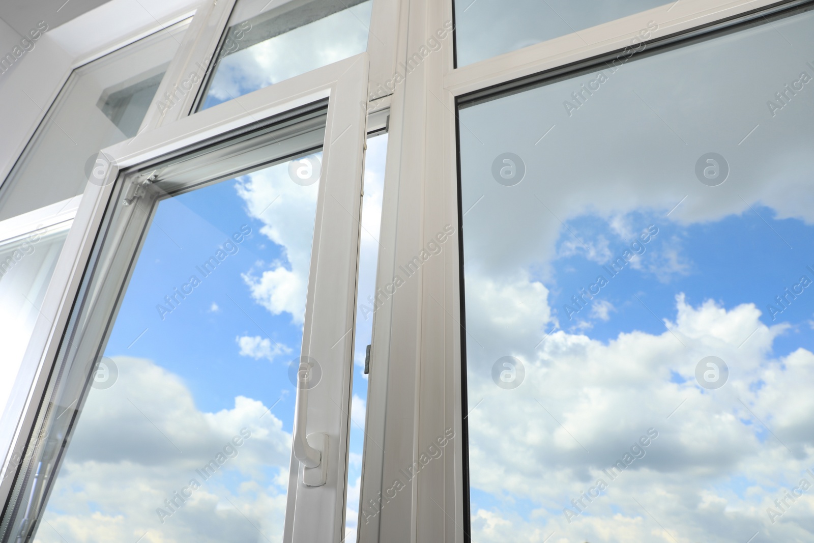 Photo of Open window with white plastic frame indoors, low angle view