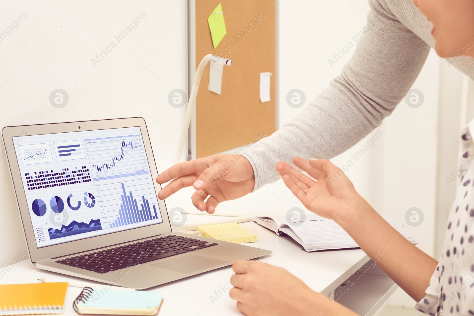 Image of Colleagues working on laptop in office, closeup. Fintech concept